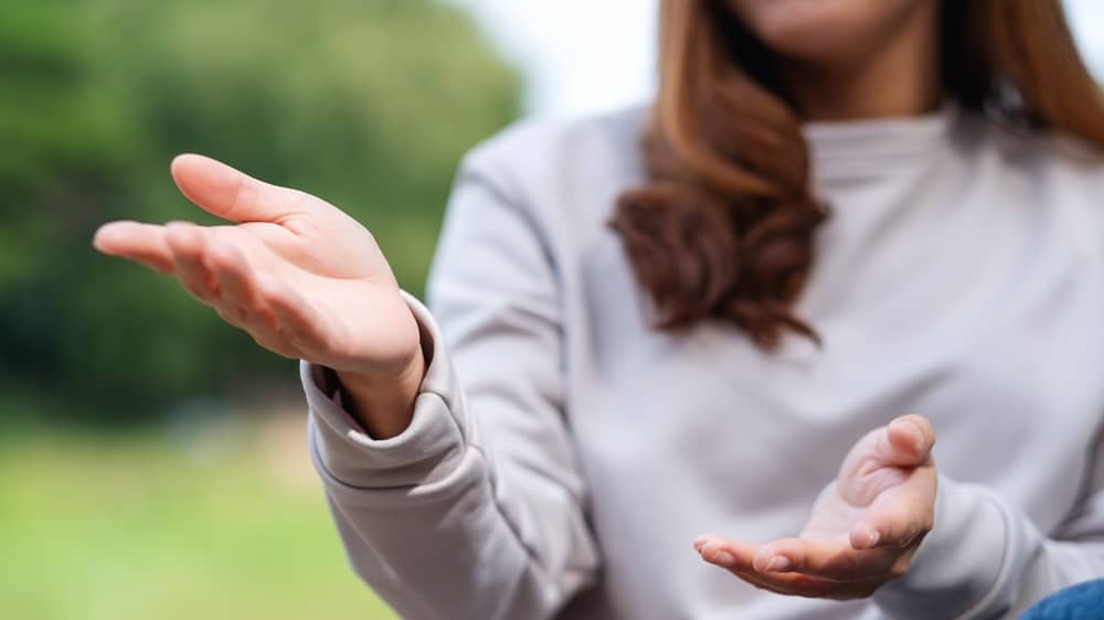 Closeup image of a young woman talking with body language